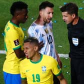 IN THE WARS: Whites winger Raphinha is left bleeding after being caught by Argentina defender Nicolas Otamendi's elbow as Lionel Messi, centre, and Vinicius Jr, left, talk to referee Andrés Cunha. Photo by Daniel Jayo/Getty Images.