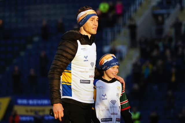 UNCLE KEV: Kevin Sinfield crossed the finish line with Rob and Lindsey Burrow's daughter Macy. Picture: PA Wire.