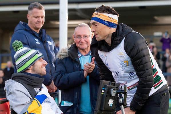 Geoff Burrow applauds as Rob Burrow greets Kevin Sinfield after his 101-mile run. Picture by Allan McKenzie/SWpix.com.