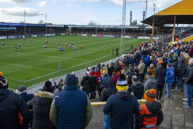 Fans watch the action from the Railway End at Wheldon Road. Picture by Tony Johnson.