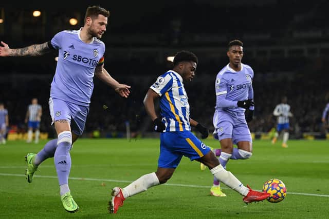 MENACE: Brighton's Tariq Lamptey, centre, skips past Leeds United captain Liam Cooper, left, as Junior Firpo, right, looks to catch up in Saturday's goalless draw at the Amex. Photo by GLYN KIRK/AFP via Getty Images.