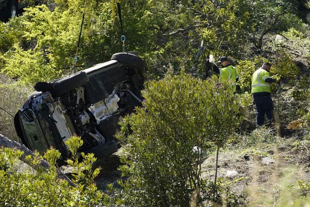 Workers collect debris beside a vehicle after a rollover accident involving golfer Tiger Woods Tuesday, Feb. 23, 2021, in Rancho Palos Verdes, California. Picture: AP/Marcio Jose Sanchez
