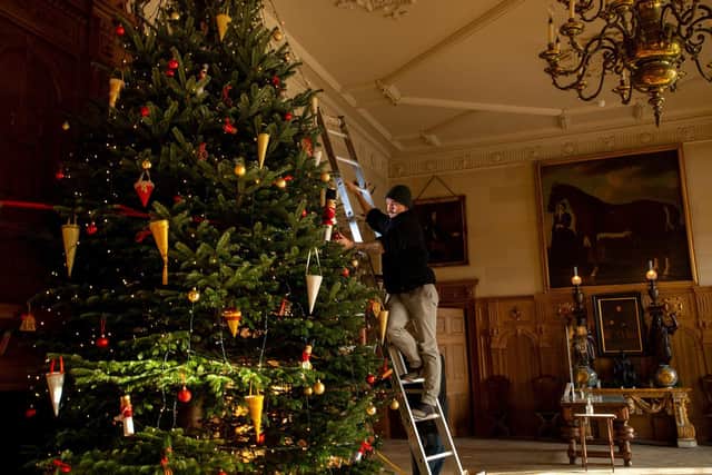 Josh Turner and Michael Clarke decorating the 18' Christmas Tree in the Great Hall, Temple Newsam House (Photo: Bruce Rollinson)