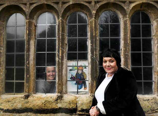 Artist Joanne Tinker (left) and Artist Louise Hepworth-Wood, designer of the Ilkley Manor House Advent Calendar, with the December 1 picture of locals sledging in Ilkley (Photo: Gary Longbottom)