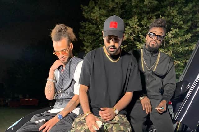 August pictured with Motion, centre, and Beenie Man on the video shoot for the Paaji remix