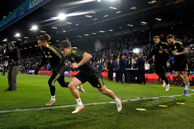 Tyler Roberts, left, warming up ahead of Tuesday's game against Crystal Palace has impressed Leeds United fans in recent outings. Picture: Nick Potts/PA Wire.