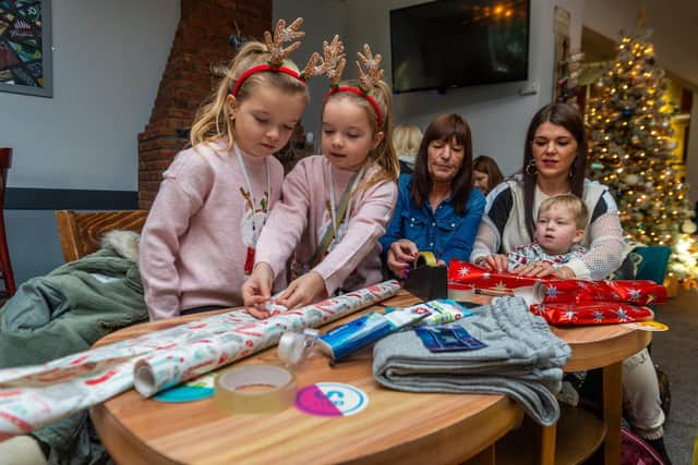 One of the many families helping with the gift wrapping. Picture: James Hardisty