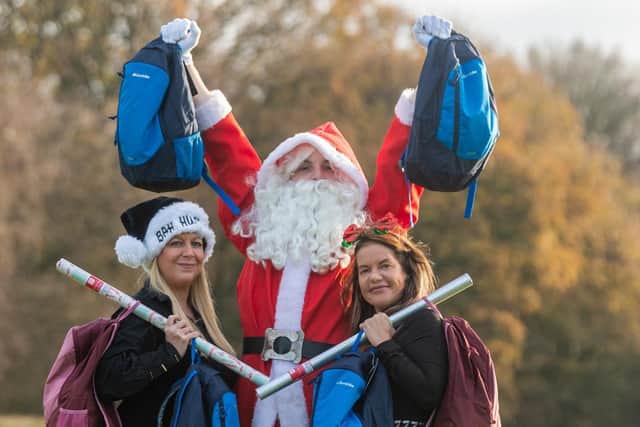 Founders of Homeless Street Angels twin sisters Shelley Joyce and Becky Joyce, with Father Christmas. Picture: James Hardisty