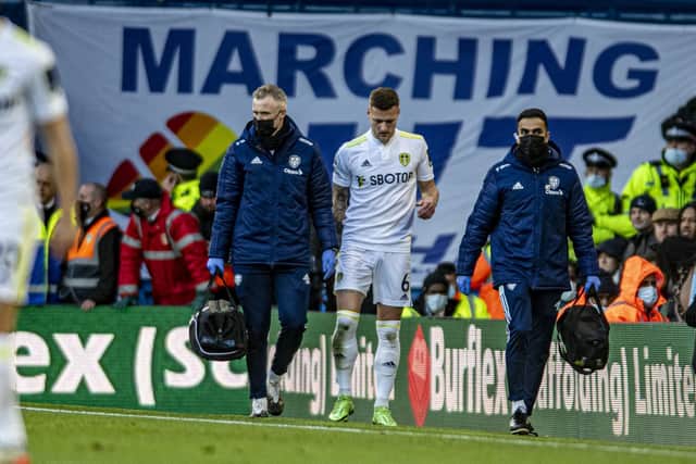 Leeds United defender Liam Cooper limps off against Brentford. Pic: Tony Johnson