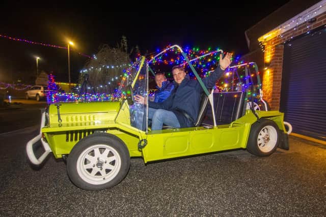 Coun James Gibson  on Farnham Close in Whinmoor, Leeds, with residents' Christmas lights display.]
It is being staged to  bring some much-needed cheer during the pandemic and raise money for St Gemma's Hospice. 

Picture: Tony Johnson