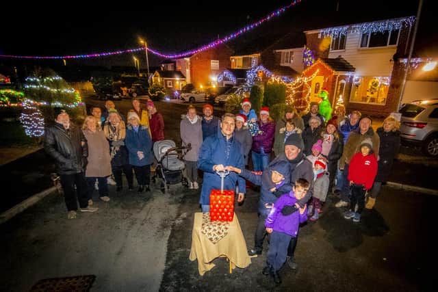 Coun James Gibson turning on the Christmas lights display on Farnham Close in Whinmoor, Leeds.
Residents  are staging the display to  bring some much-needed cheer during the pandemic and raise money for St Gemma's Hospice. 

Picture: Tony Johnson