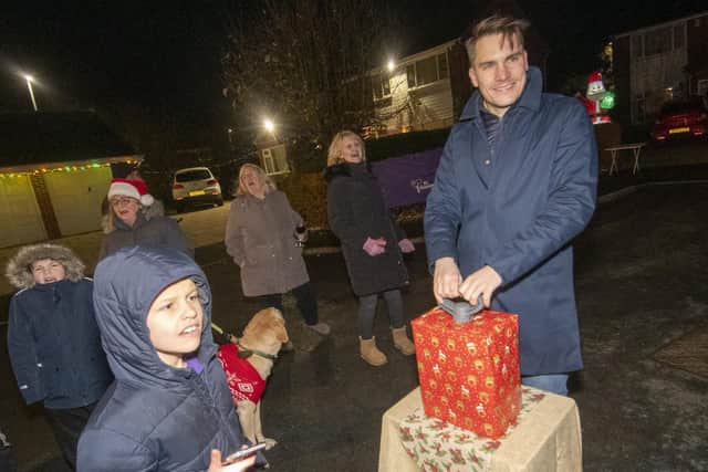 Coun James Gibson turning on the Christmas lights display on Farnham Close in Whinmoor, Leeds.
Residents  are staging the display to  bring some much-needed cheer during the pandemic and raise money for St Gemma's Hospice. 

Picture: Tony Johnson