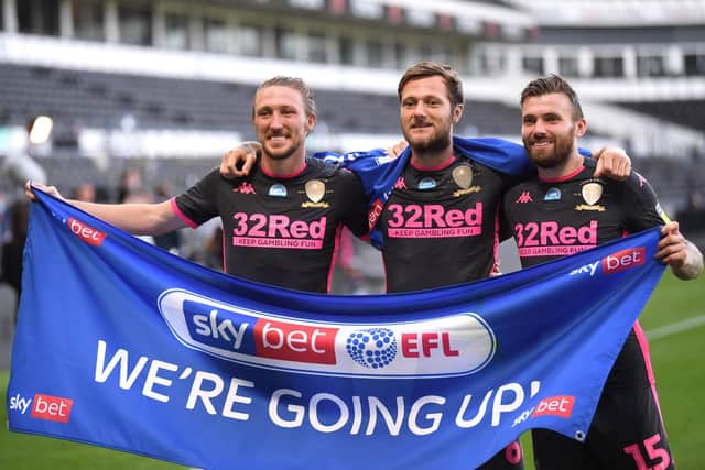 Stuart Dallas celebrates Leeds United's promotion to the Premier League with Luke Ayling and Liam Cooper in July 2020. Pic: Laurence Griffiths.