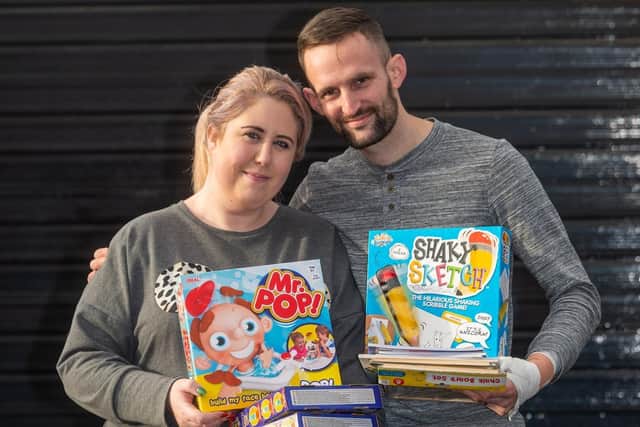 Pictured Mark Brooks and wife Bekki, 30, with some of the toys they have collected for Lineham Farm. Photo: James Hardisty