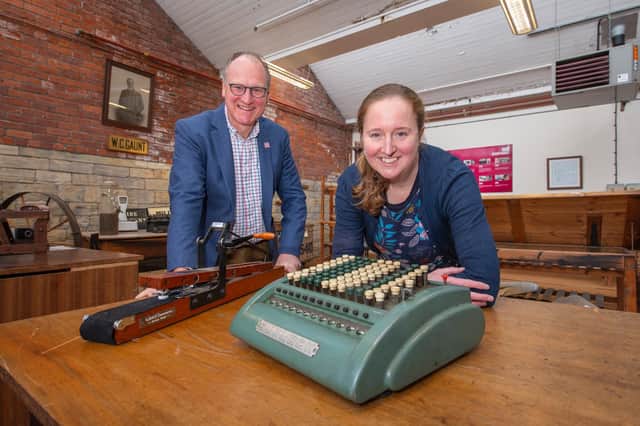 William Gaunt and Rachel Moaby with a comptometer, which was the first mechanical calculator used in the mill office, in the foreground and a crockmeter that tests the colour of the dye.