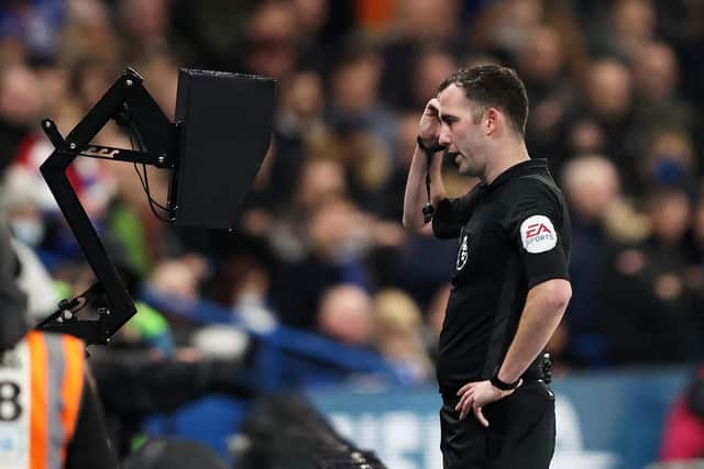 Referee Chris Kavanagh consults pitchside VAR monitor before awarding Chelsea's first penalty. Pic: Marc Atkins.