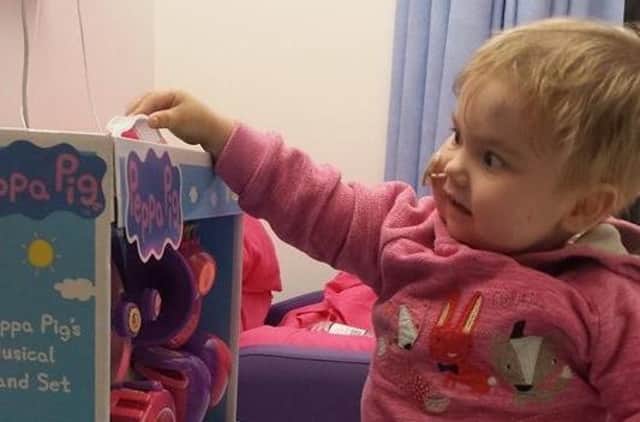 Mia Mason with her Peppa Pig donated gift at Leeds Children's Hospital