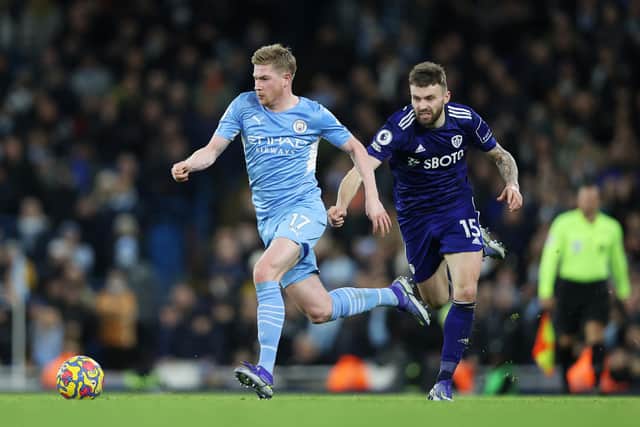 PAINFUL NIGHT: Leeds United's Stuart Dallas chases Manchester City star Kevin De Bruyne during Tuesday night's 7-0 hammering at the Etihad. Photo by Clive Brunskill/Getty Images.