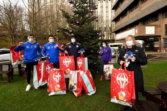 Leeds Rhinos players' Jack Broadbent, Rhyse Martin and Bodene Thompson deliver Christmas presents to Helen McDonald (Events Fundraising Officer) and Lisa Beaumont (Therapeutic and Specialised Play Manager) from Leeds Children's Hospital. (SIMON HULME)