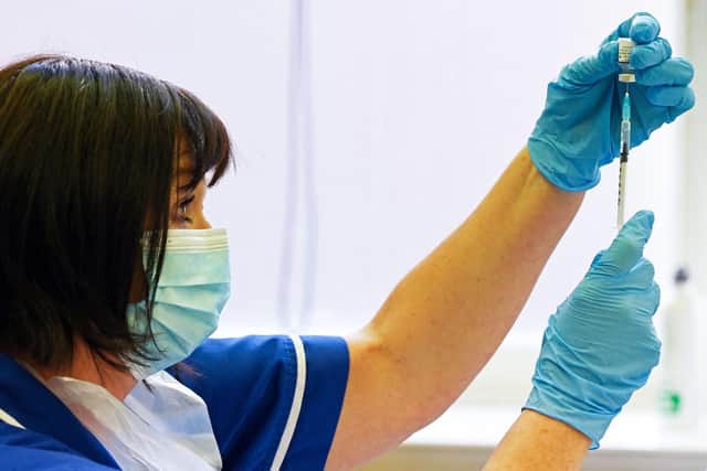 A nurse prepares a dose the Pfizer-BioNtech  vaccine.

Photo by Paul Ellis/AFP via Getty Images)