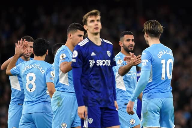 Diego Llorente shows his frustration as Manchester City's Riyad Mahrez, second right, celebrates scoring his side's fourth goal of the game on Tuesday night. Picture: Martin Rickett/PA Wire.