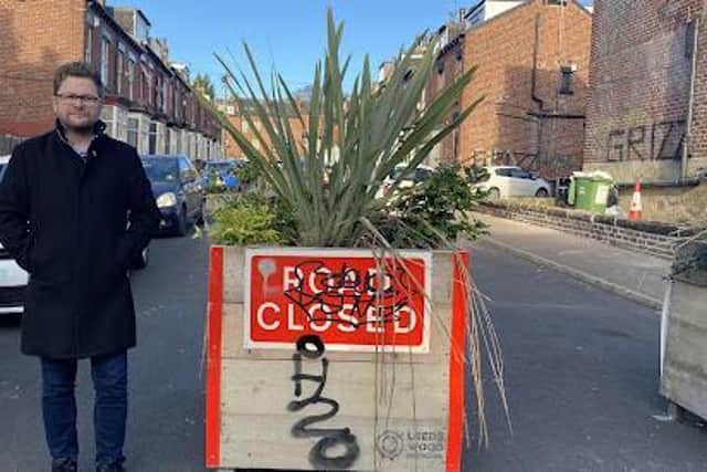 Coun Neil Walshaw, pictured with one of the traffic-blocking planters in Hyde Park, Leeds.