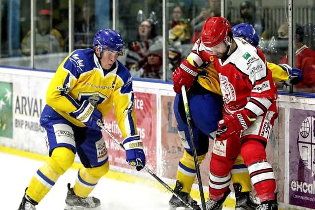 BOARD BATTLE: Cole Shudra tussles for possession of the puck on Friday night. Picture courtesy of David North/Swindon Wildcats.