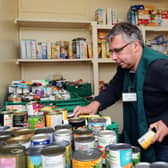 Volunteer Graham Neal packs food at the Leeds and North West food bank in Moortown. Photo: Jonathan Gawthorpe