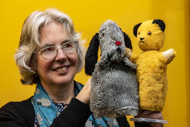 Curator of Leeds History, Kitty Ross, with Sooty and Sweep toys on display at Abbey House Museum (Photo: Tony Johnson)