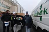 LUFC Supporters Trust foodbank collection before the Leeds United v Arsenal game. Pictured are Gib Aslam, Amie Thompson and Wendy Doyle. Photo: Bruce Rollinson