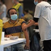 A person receives a Covid-19 vaccination at Wembley Stadium in London, as the coronavirus booster vaccination programme is ramped up to an unprecedented pace of delivery, with every eligible adult in England being offered a top-up injection by the end of December.