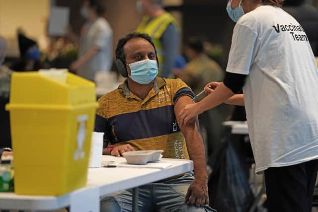 A person receives a Covid-19 vaccination at Wembley Stadium in London, as the coronavirus booster vaccination programme is ramped up to an unprecedented pace of delivery, with every eligible adult in England being offered a top-up injection by the end of December.