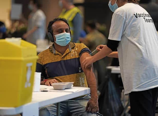 A person receives a Covid-19 vaccination at Wembley Stadium in London, as the coronavirus booster vaccination programme is ramped up to an unprecedented pace of delivery, with every eligible adult in England being offered a top-up injection by the end of December.