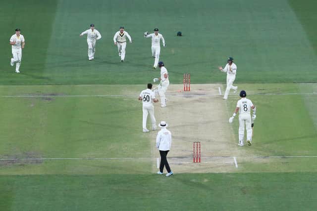 Australia celebrate as England's Jos Buttler treads on his own stumps accidentally to be dismissed on day five of the second Ashes Test at the Adelaide Oval. Picture: Jason O'Brien/PA