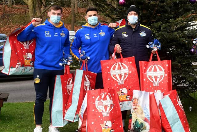 Rhyse Martin - centre, along with Jack Broadbent, left and Bodene Thompson - delivered Christmas gifts to children at Leeds General Infirmary last week. Picture by Simon Hulme.