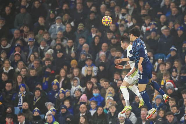 BIG BLOW - Jack Harrison sustained a knock in this aerial challenge with Arsenal's Takehiro Tomiyasu in Leeds United's Elland Road defeat but he could be key against Liverpool. Pic: Getty