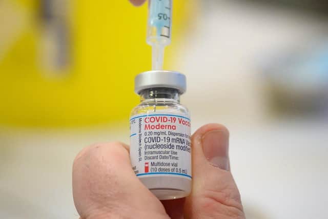 Medical staff and volunteers prepare shots of the Moderna Covid-19 vaccine at a vaccination centre. Curry house customers are being urged to get a booster with their bhaji and a jab with their jalfrezi as a restaurant becomes the latest NHS pop-up coronavirus vaccination site. PIC: Leon Neal/PA Wire
