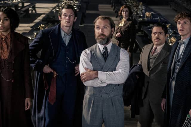 Photo of (left to right) Jessica Williams as Eulalie “Lally” Hicks, Callum Turner as Theseus Scamander, Jude Law as Albus Dumbledore, Fionna Glascott as Minerva McGonagall, Dan Fogler as Jacob Kowalski and Eddie Redmayne as Newt Scamander, appearing in the film Fantastic Beasts: The Secrets Of Dumbledore.
