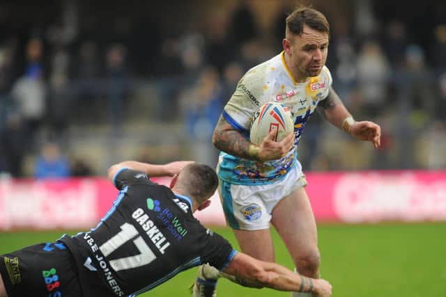 Rhinos' man oif the match Richie Myler evades a tackle by new Trinity signing Lee Gaskell. Picture by Steve Riding.