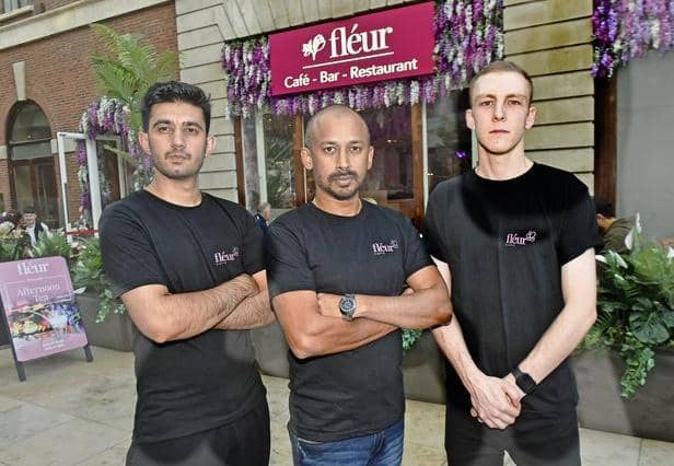 Fleur Cafe will be giving free meals to those in need on New Year's Day. Bobby Geetha with Fleur chefs Zubair, left, and George Smith. Photo: Steve Riding
