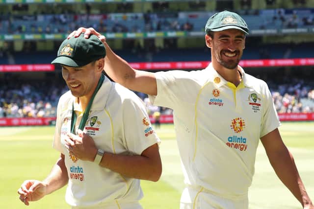 Home-town hero: Australia's Scott Boland is congratulated by Mitchell Starc.