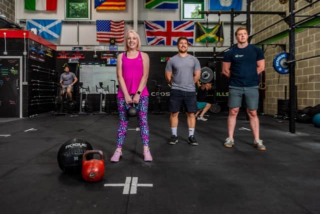 Laura Collins and Graft CrossFit Crosshills co-owner Dan Jeffrey and coach Chris Hull.