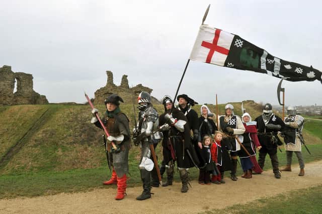 Members of the Harrington Household Yorkists from the Federation of the War of the Roses march past Sandal castle at the end of a previous year's Battle of Wakefield memorial march.

Photo: Gary Longbottom