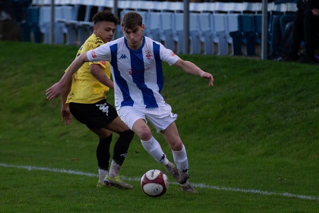 Ben Atkinson on the ball as he aims to get away from Pontefract Collieries' Joao Rangel.