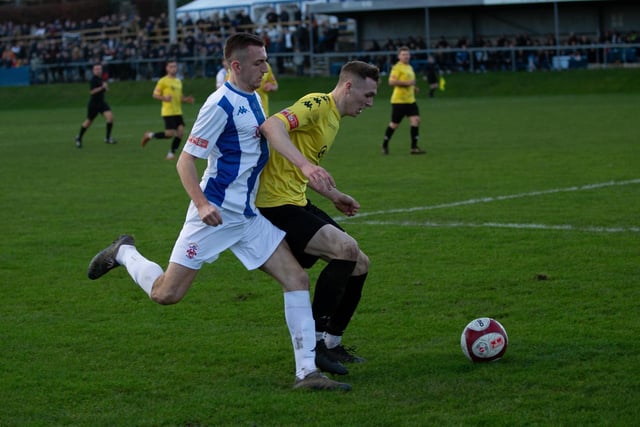 Oliver Fearon cannot get the ball off Pontefract Collieries' Jack Shepherd.