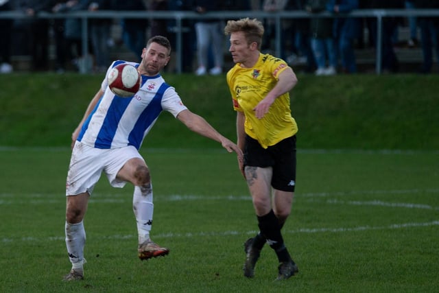 Liversedge striker Gavin Allott aims to control the ball as he takes on defender Spencer Clarke.