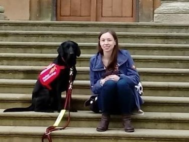 Zoe with Stowe, the black labrador who changed her life