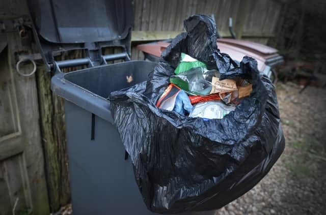 File: Black rubbish bin Hastings Borough Council. SUS-220202-083120001