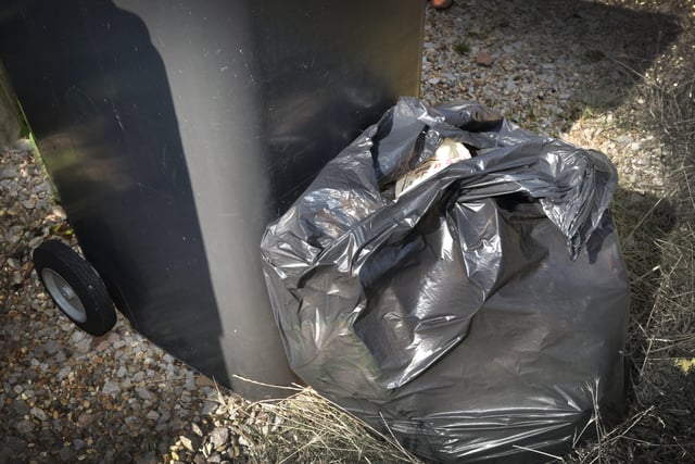 File: Black rubbish bin Hastings Borough Council. SUS-220202-082950001