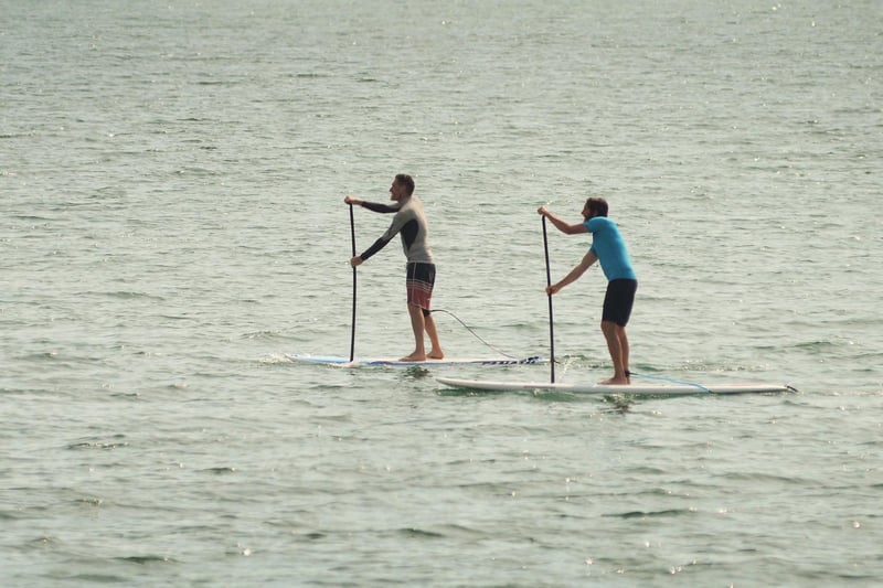 Paddle boarders enjoy the good weather